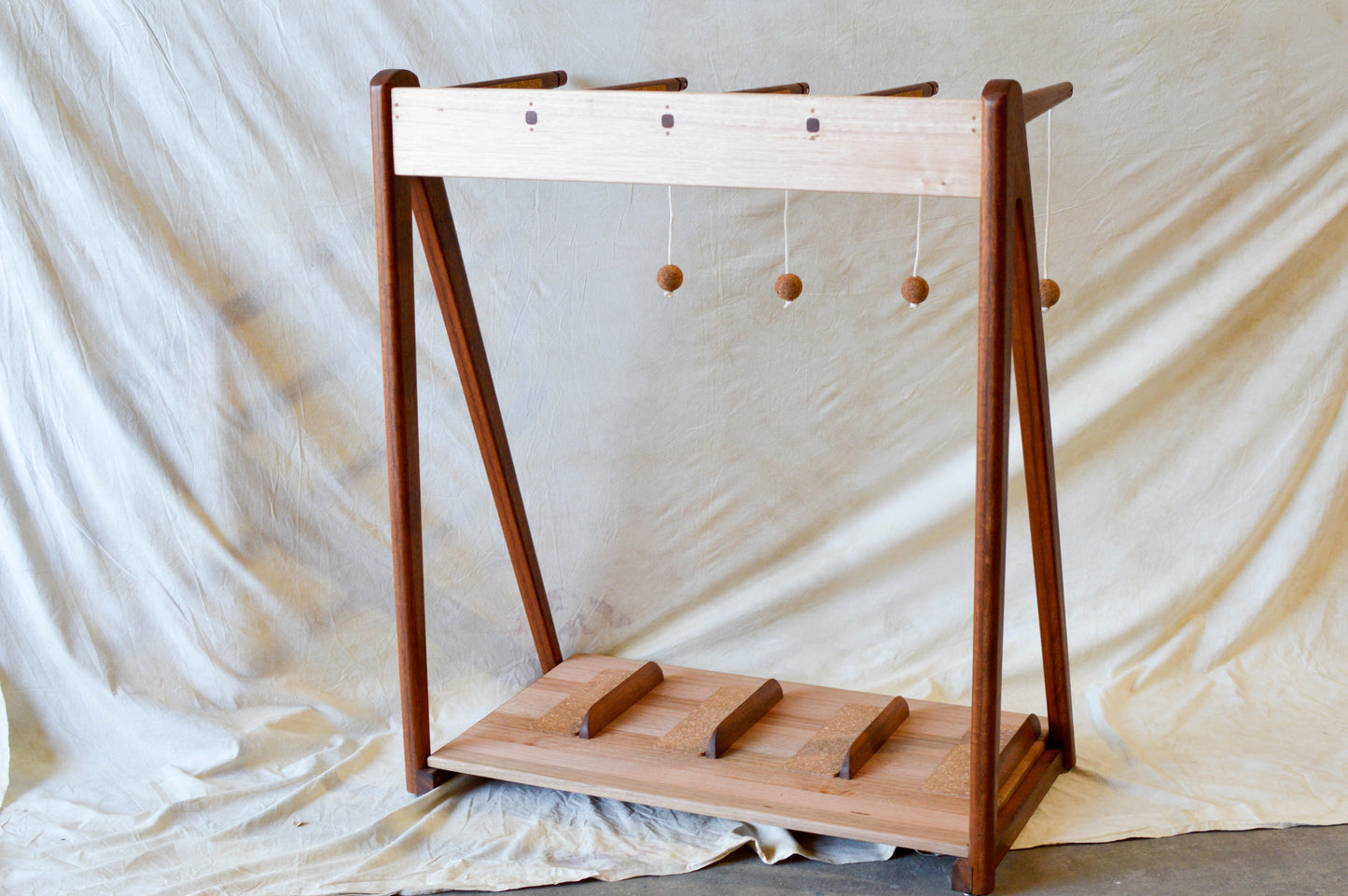 Handcrafted mid-century modern surfboard rack in walnut-stained Tasmanian oak, with marine rope and wooden bead detail, made in Sydney by MCM Atelier