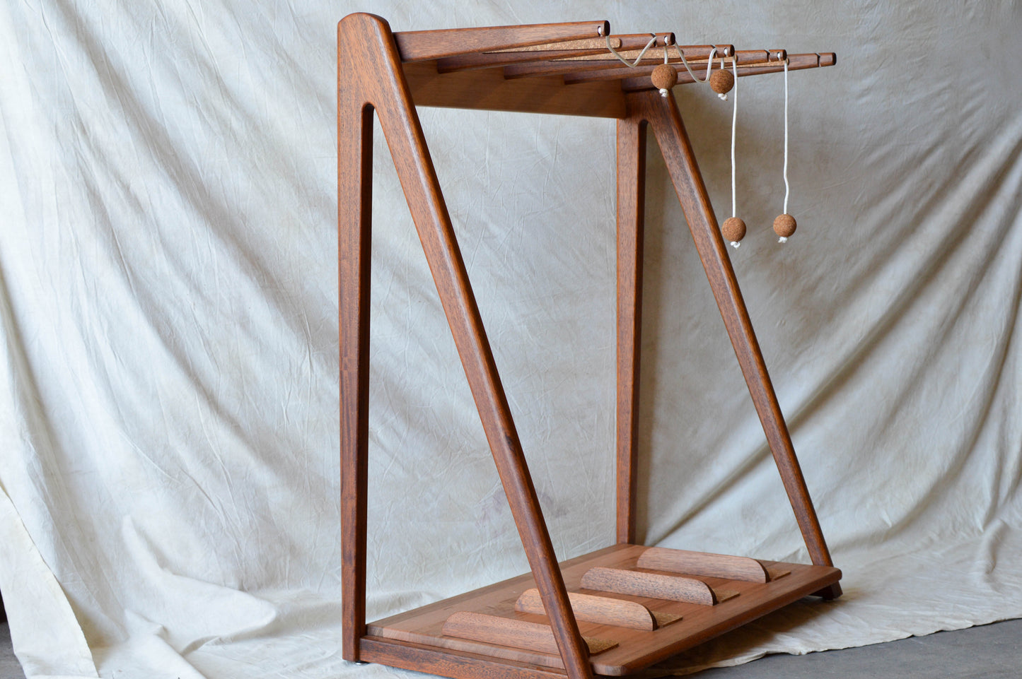 Handcrafted mid-century modern surfboard rack in walnut-stained Tasmanian oak, with marine rope and wooden bead detail, made in Sydney by MCM Atelier