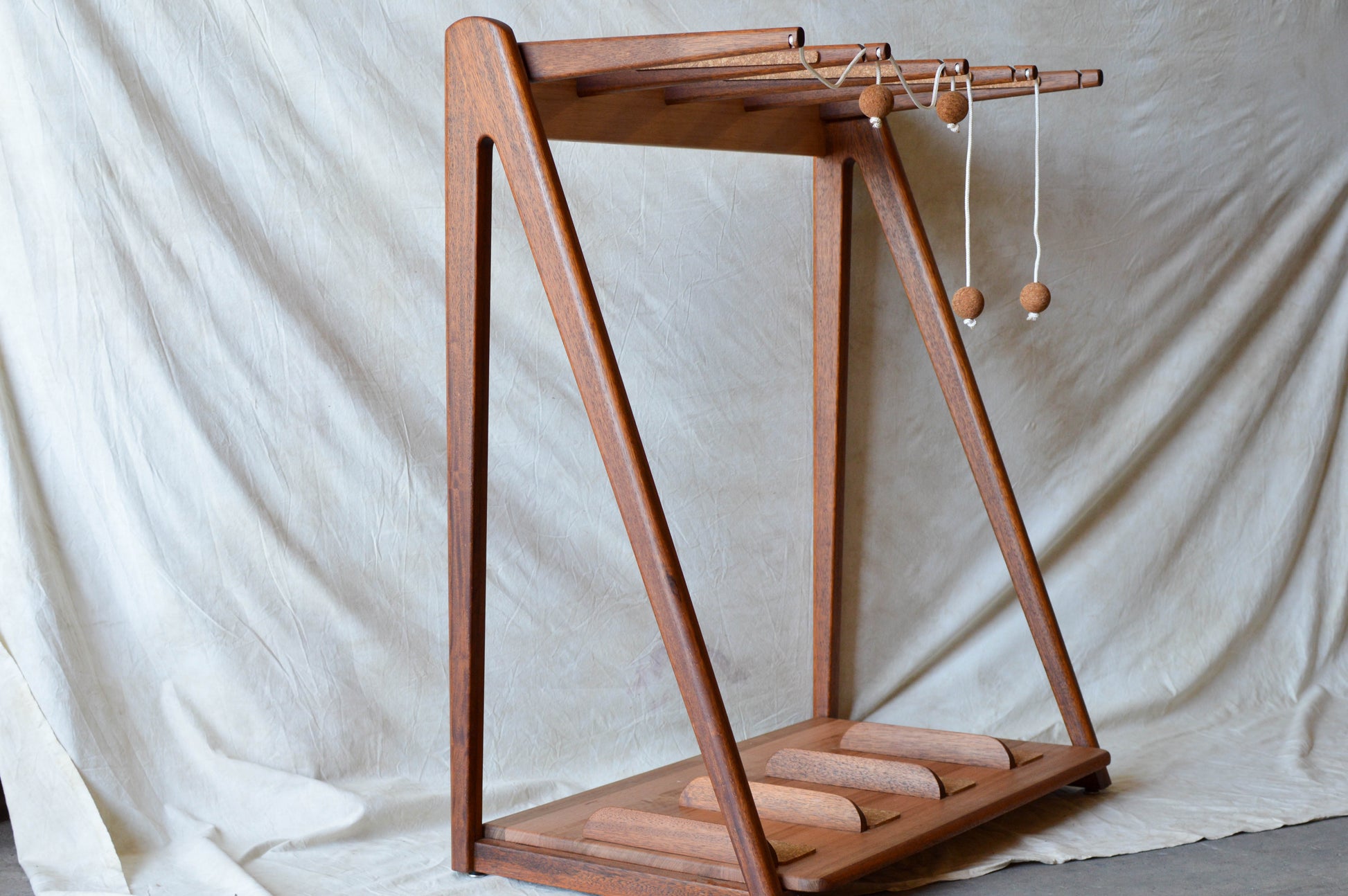 Handcrafted mid-century modern surfboard rack in walnut-stained Tasmanian oak, with marine rope and wooden bead detail, made in Sydney by MCM Atelier