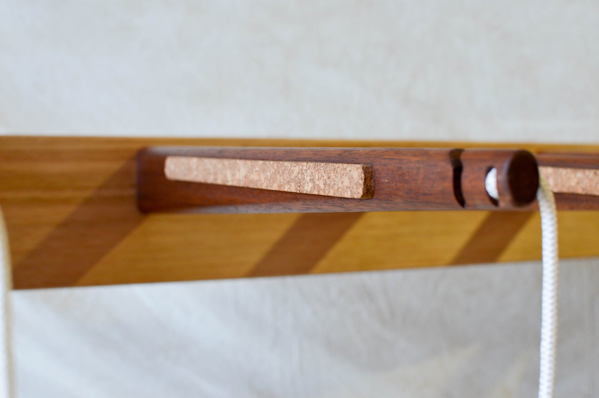 Handcrafted mid-century modern surfboard rack in walnut-stained Tasmanian oak, with marine rope and wooden bead detail, made in Sydney by MCM Atelier
