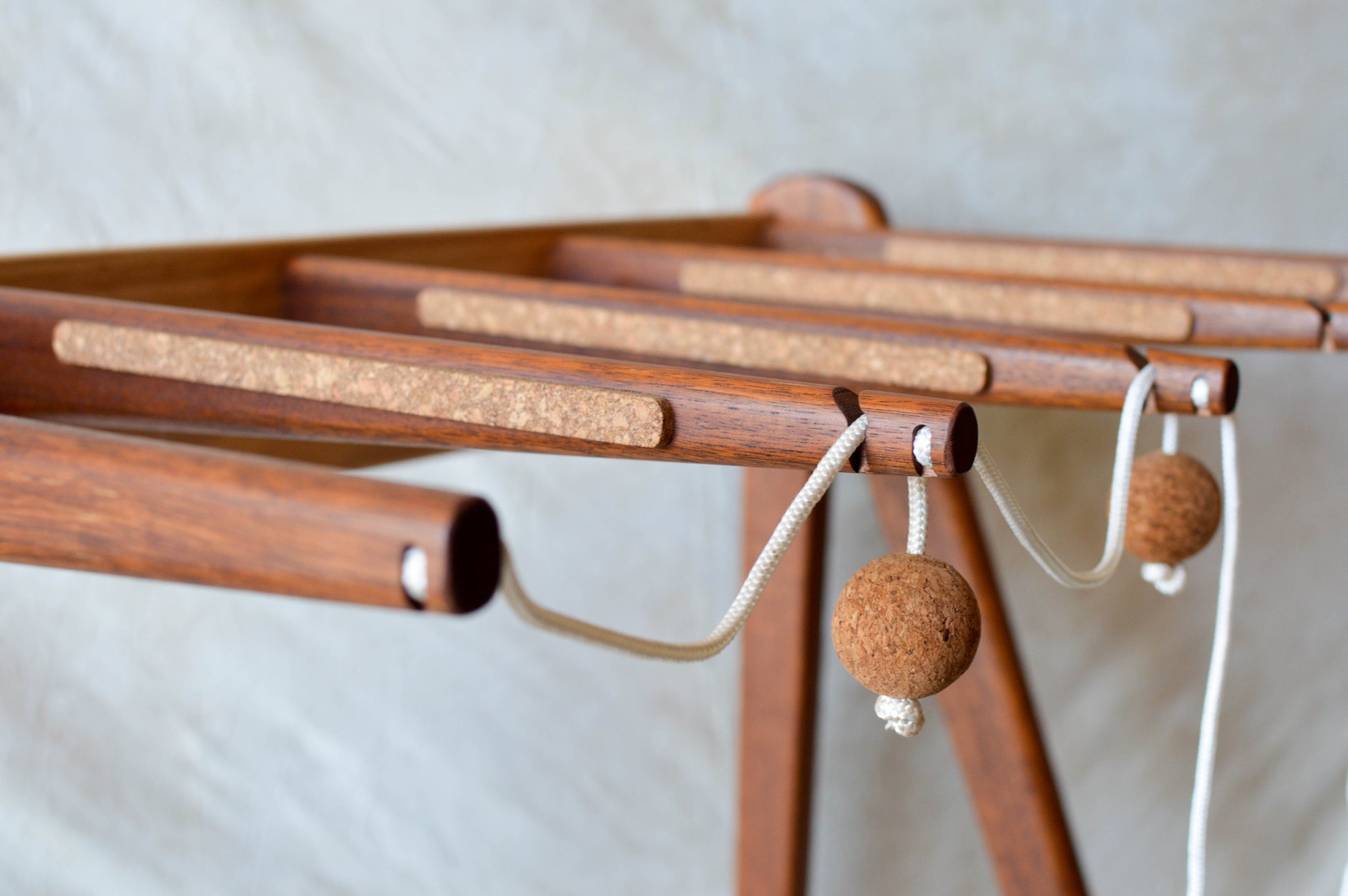 Handcrafted mid-century modern surfboard rack in walnut-stained Tasmanian oak, with marine rope and wooden bead detail, made in Sydney by MCM Atelier