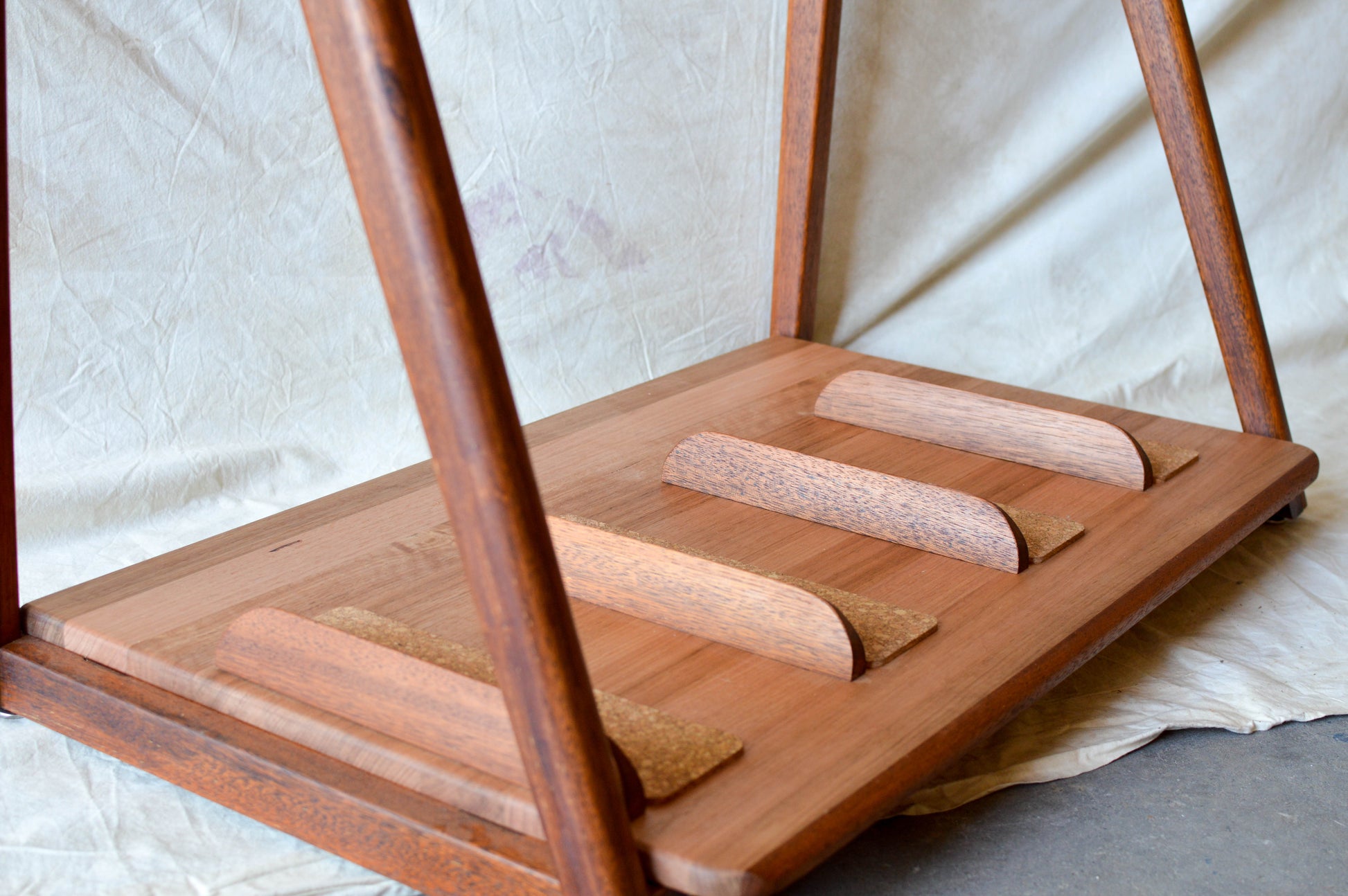 Handcrafted mid-century modern surfboard rack in walnut-stained Tasmanian oak, with marine rope and wooden bead detail, made in Sydney by MCM Atelier
