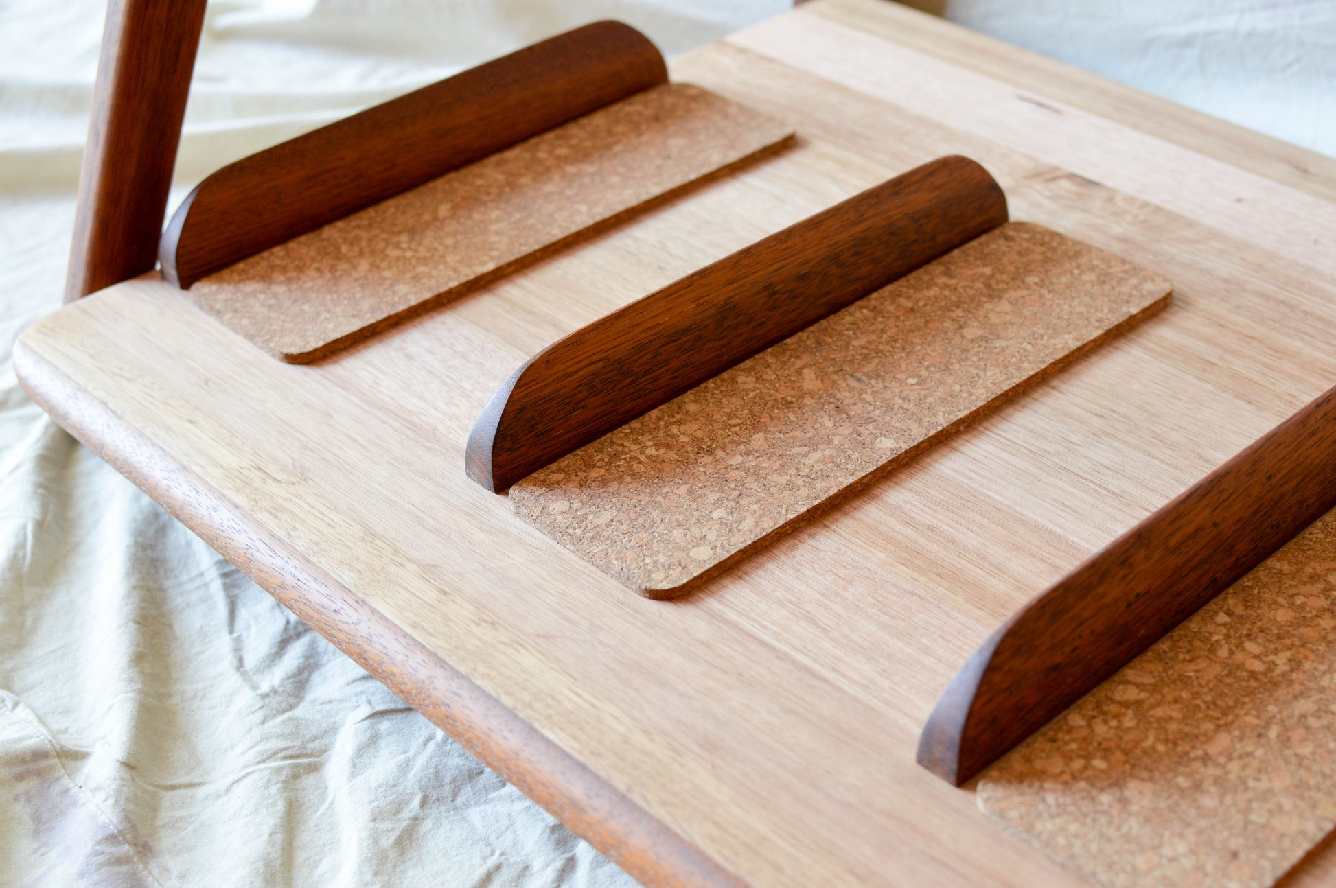 Handcrafted mid-century modern surfboard rack in walnut-stained Tasmanian oak, with marine rope and wooden bead detail, made in Sydney by MCM Atelier