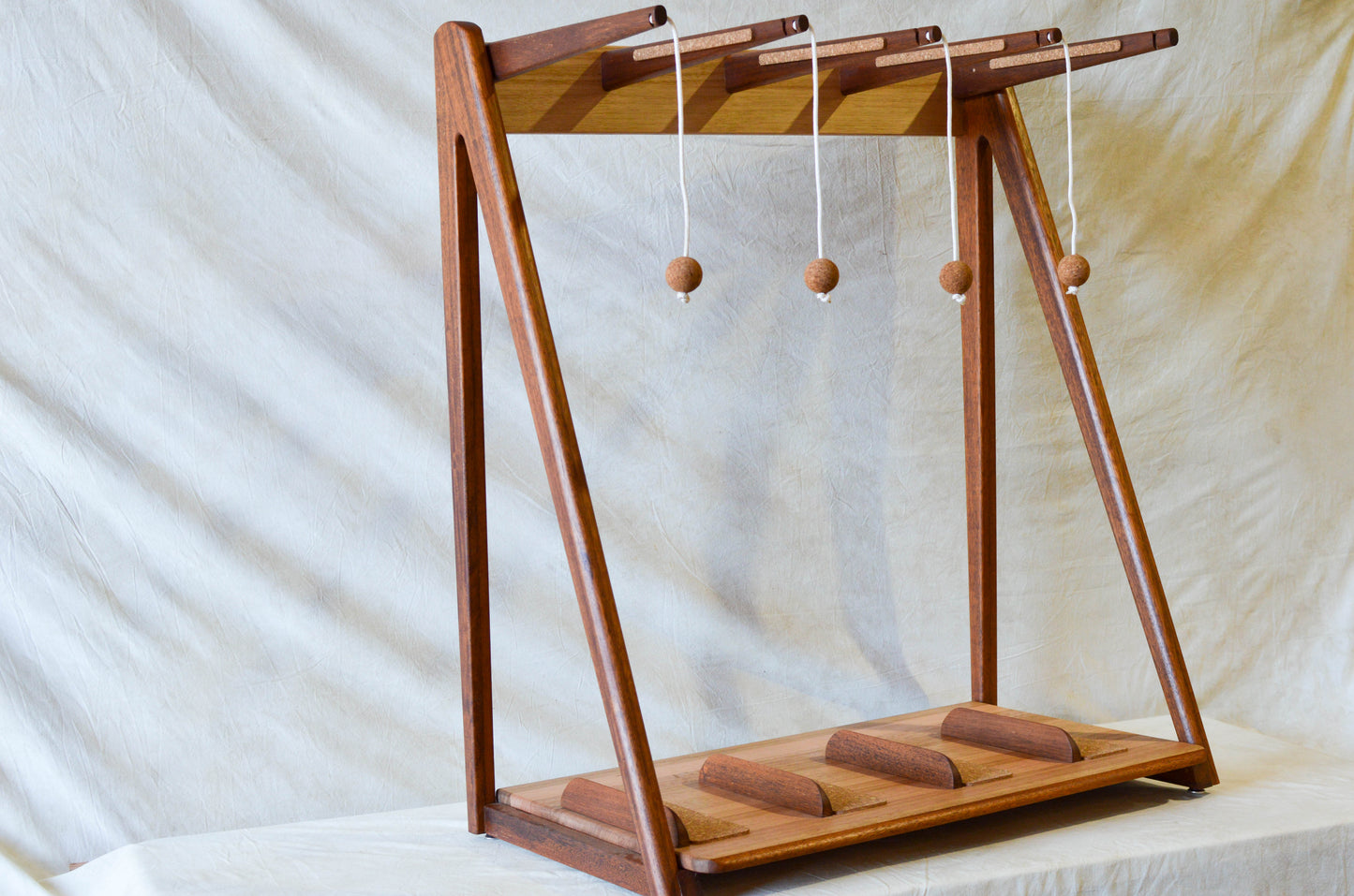 Handcrafted mid-century modern surfboard rack in walnut-stained Tasmanian oak, with marine rope and wooden bead detail, made in Sydney by MCM Atelier